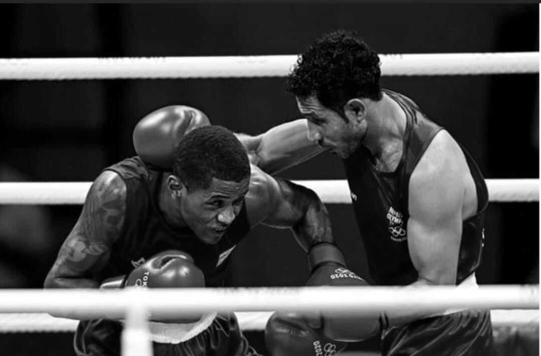 Boxing coach supporting an athlete in the ring